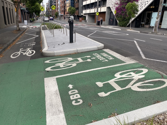Example of some of the cool features in Melbourne’s emerging bike infrastructure. The picture shows street destinations and directions painted onto the bike lanes. I was semi-lost here and found it so helpful. Not in braille but in contrasting paint colours.