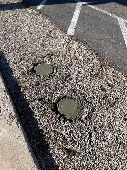 Holes filled with concrete.