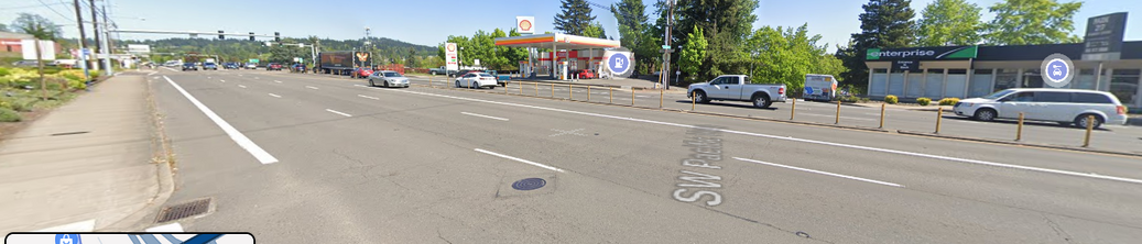 bus stop is a blue stick halfway down the sidewalk on the left of the image, Barbur has a no-turns centerline divider here that sends traffic down to Hall Blvd.  Every intersection is a crosswalk.