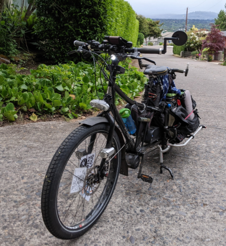 Black xtracycle longtail cargo bike with dirt on everything but the new tire