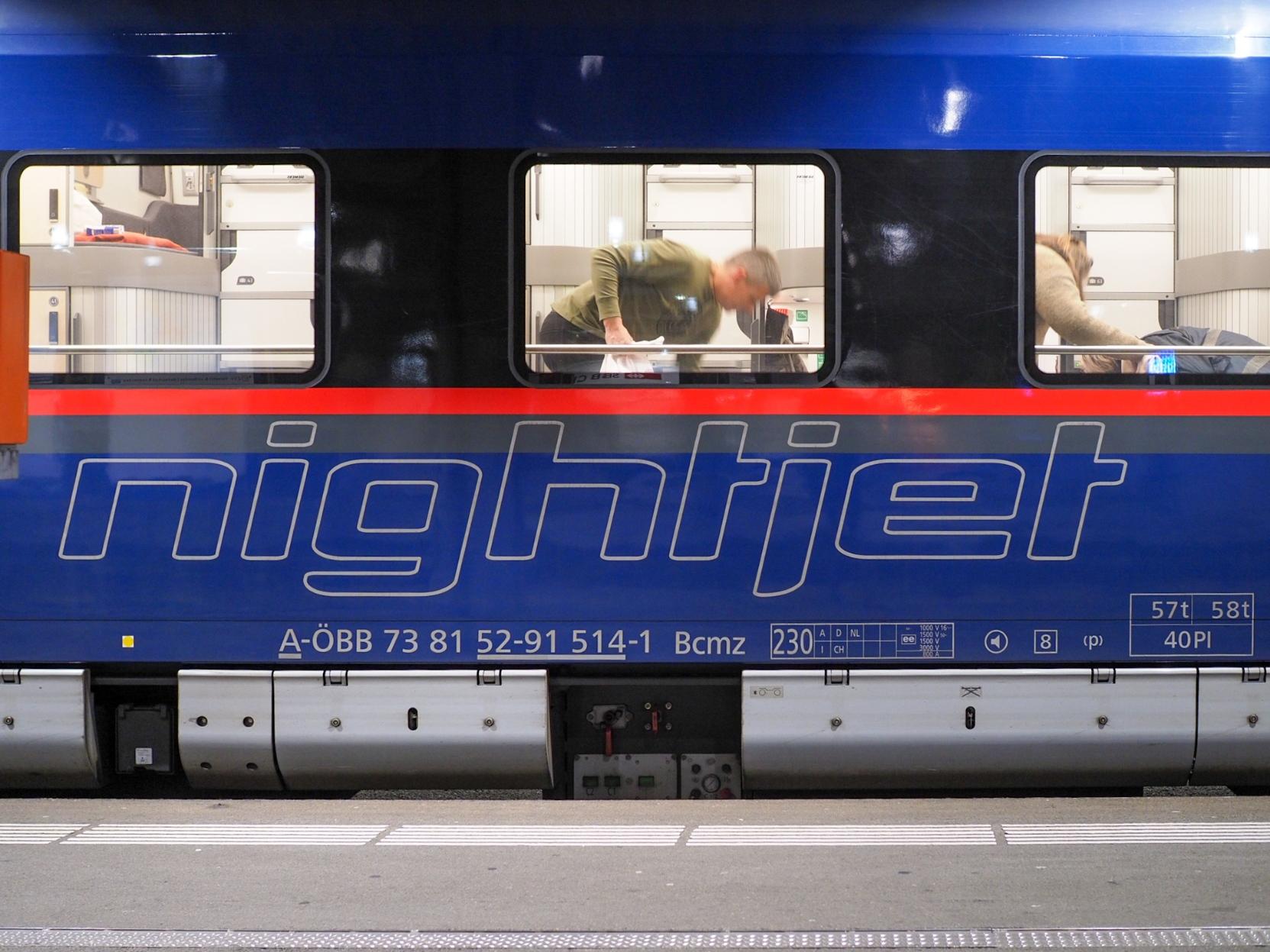 Nightjet at the platform. Through the windows, you can see passengers getting their cabin ready.