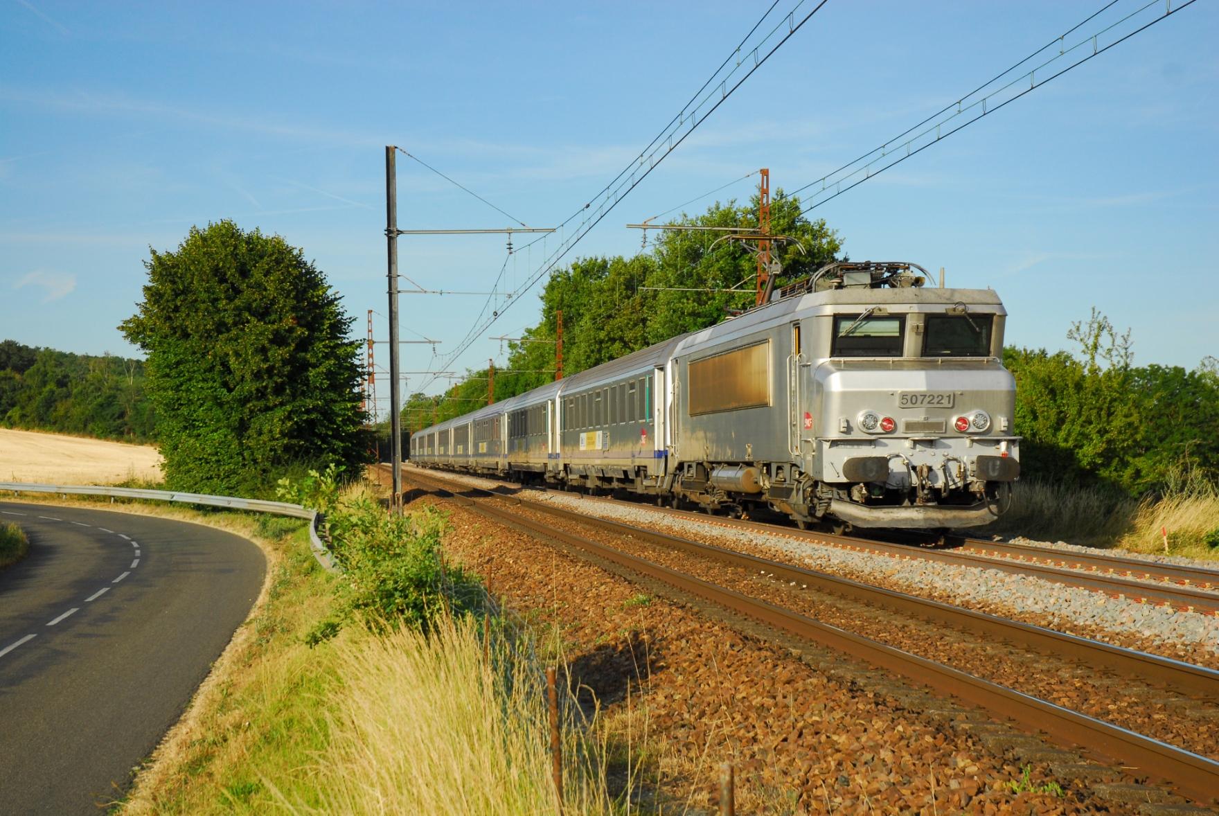 The same spot as before where the railway line passes between two bushes next to the little road. Only this time, it's a class BB7200 Nez Cassé in fantôme livery with 8 Corail carriages. As the photo is taken from a slightly lower position as usual, the loco looks narrow and high, a bit like the first Nez Cassé ever, the CC 40100.