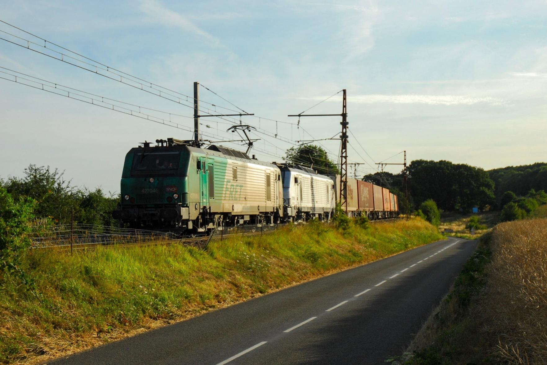 Two Prima hauling a container trains