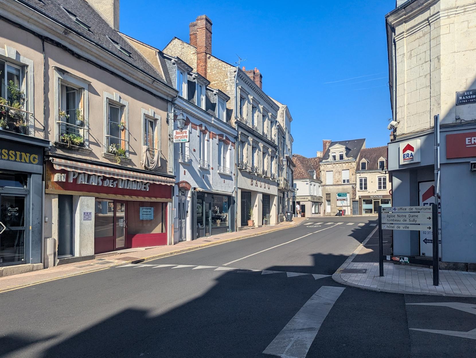The centre of Nogent-le-Rotrou with older houses in the hot evening sun