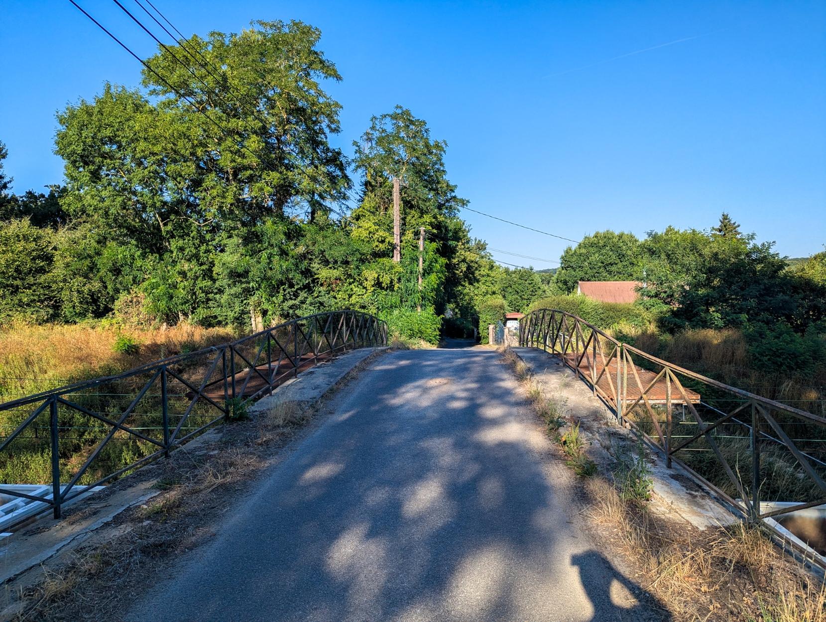 Old bridge of a small road over the railway tracks