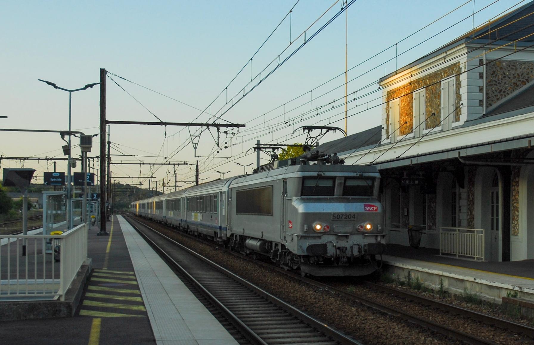 A fantôme Nez Cassé in front of Corail carriages next to the beautiful station building of Nogent-le-Rotrou