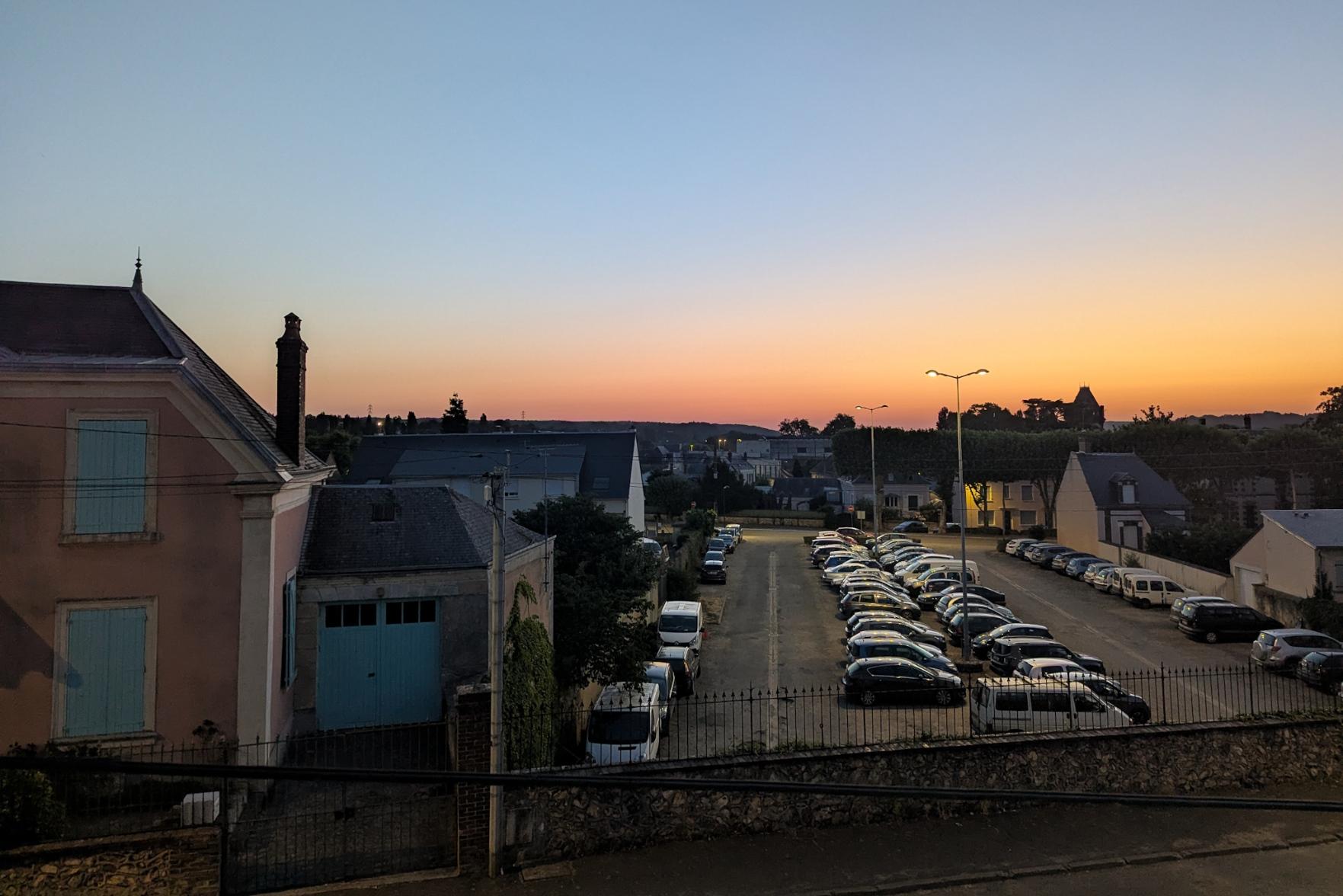 Dawn over a little town. Orange colours on the horizon.