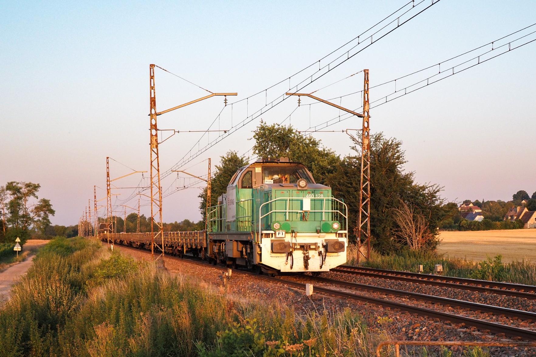 A diesel loco, in former Fret SNCF colours, at the rear of a construction train