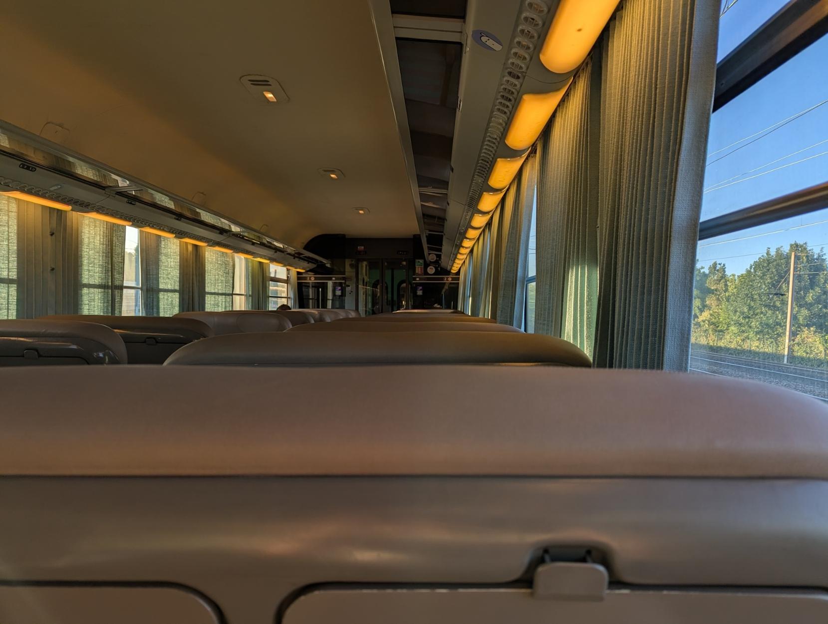 Interior of a dimly lit Corail train in the evening
