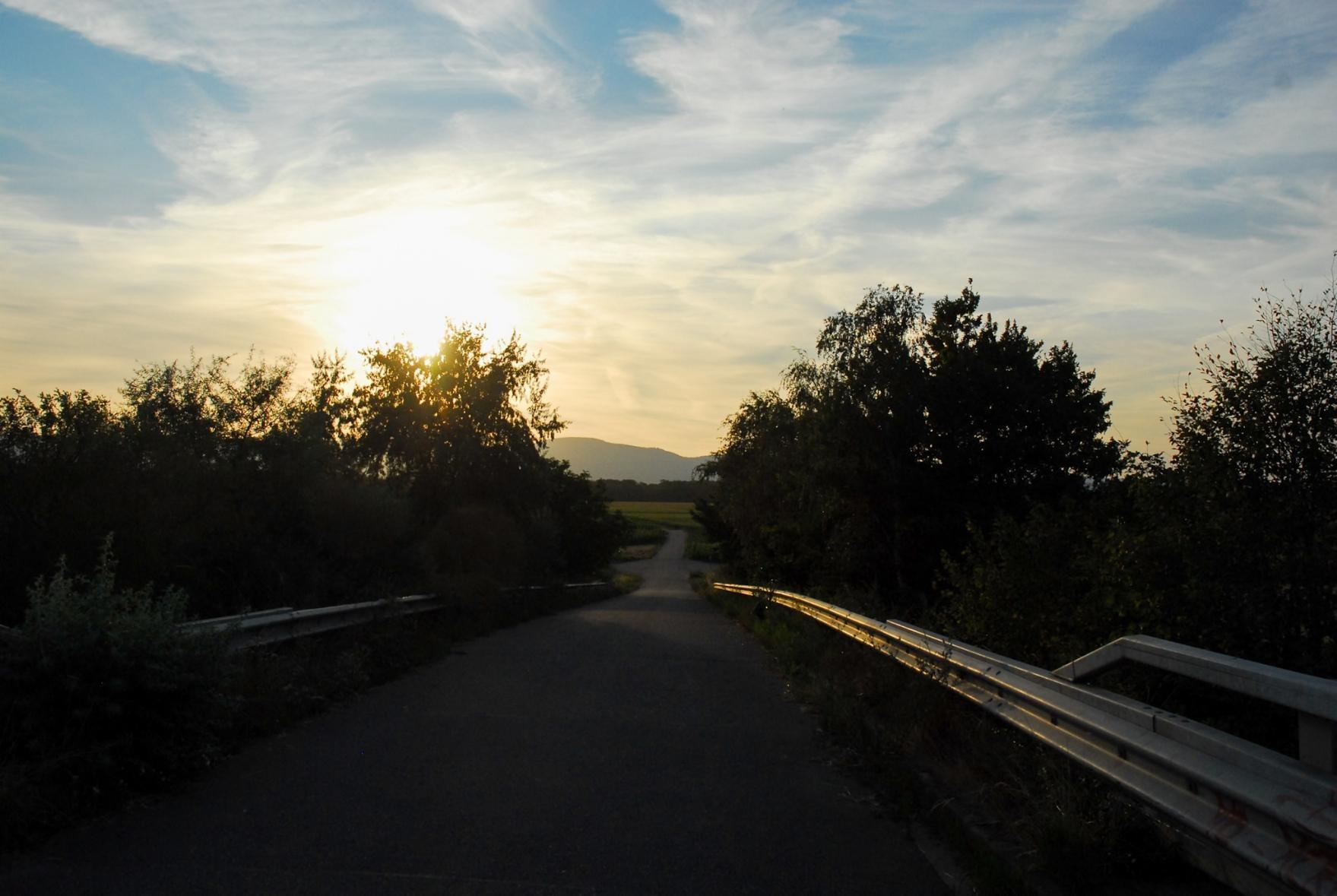 Light clouds in front of the sun over the Voges mountains.