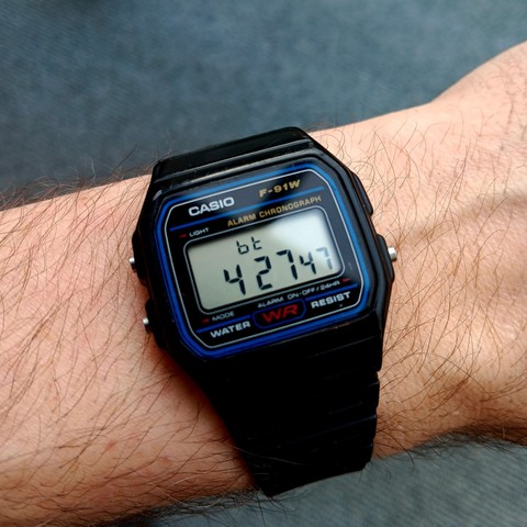 A classic black Casio F-91W with "bt" at the top of the screen. Time shown is @427 .beats or 10:16 [+01:00].