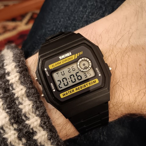 A Skmei 1413 digital watch in the style of a Casio F-94W. The time shown is 20:06:35.