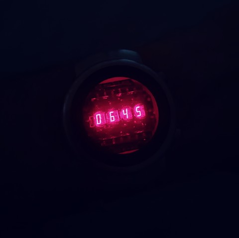 Picture of my wrist with the time shown using bright red LEDs of the style found in 1970s watches. This and sharp.