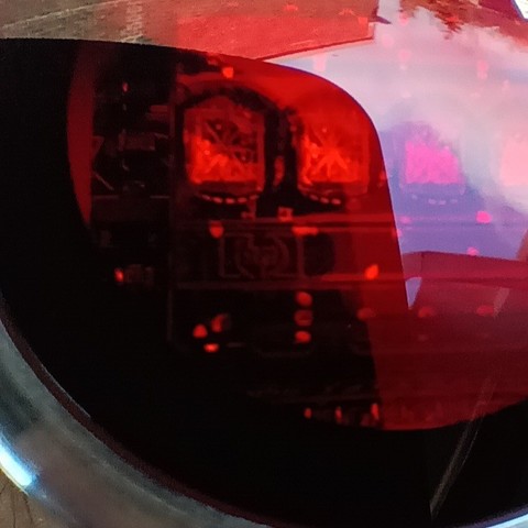 Close up picture of the face of an LED watch. It is just possible to make out a "hp" logo in the centre. 