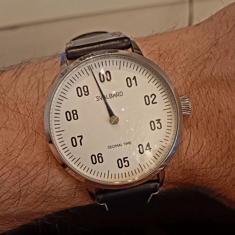 Decimal watch showing the time as roughly 9:64 decimal [23:08].