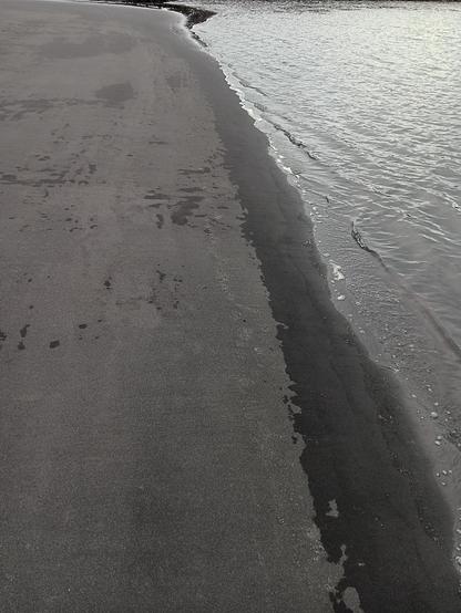 A beach with black sand