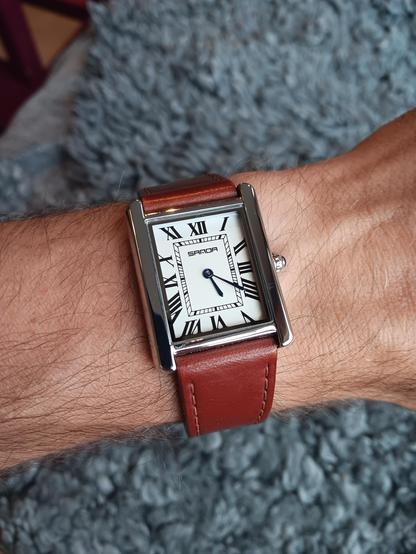 Sanda Tank, which looks like a cheap clone of a Cartier, on a Cognac leather, stiched strap by Marloe.