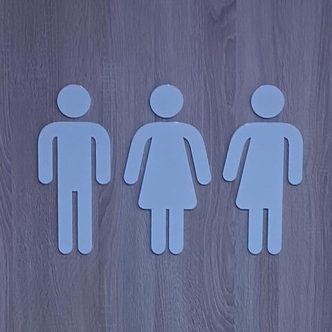 Toilets sign with classic male, female outlines and one which is a mixture of both. 