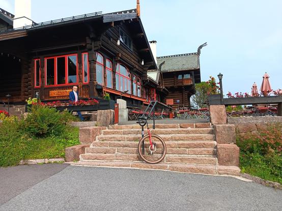 Frognerseteren cabin with a unicycle resting on the steps in front.