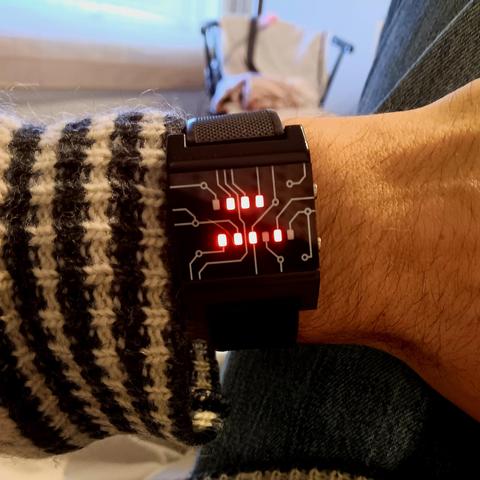 A binary watch with red LEDs representing 7:58 on two rows. Hours on top and minutes below, like so:

0111
111010

(Where 1 is a lit LED and 0 is unlit.)