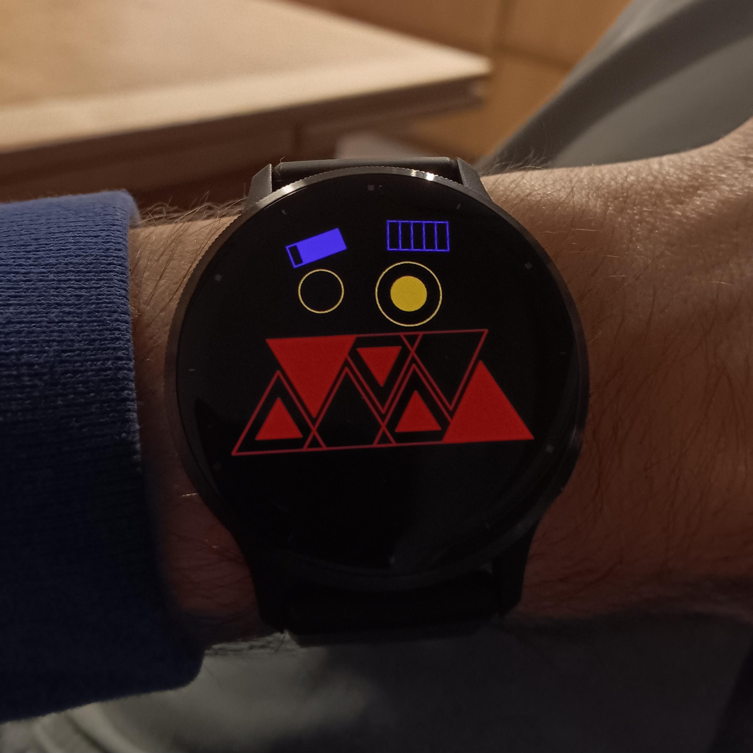 Watch face showing 21:32 in ternary via the teeth and the 24th in base-six via the eyebrows.
5 seconds via the pupils in decimal.