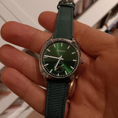 Watch with classic railway style hands and markers. In green with a green strap. 