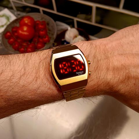 Golden coloured LED watch with large digits. 