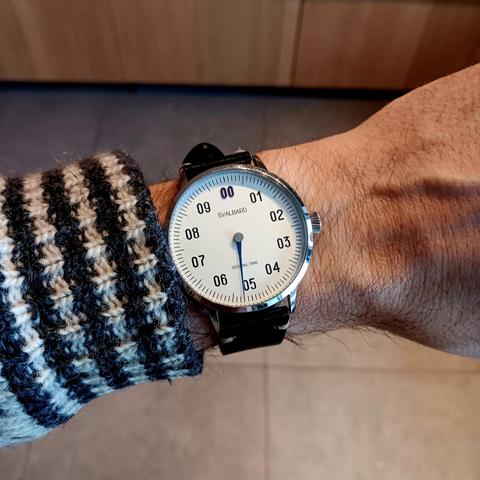 One handed decimal watch showing 5:20