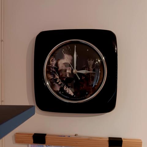 Clock with an Elvis motif in the background. The hands appear to show 3:00 but this clock runs widdershins, so it is actually 9:00