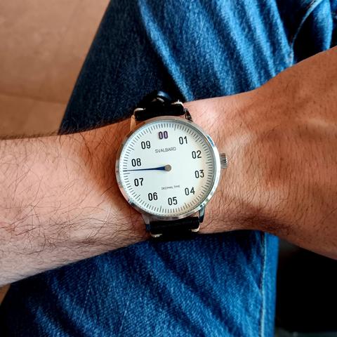 Decimal, single handed watch showing the time as approximately 7.61.