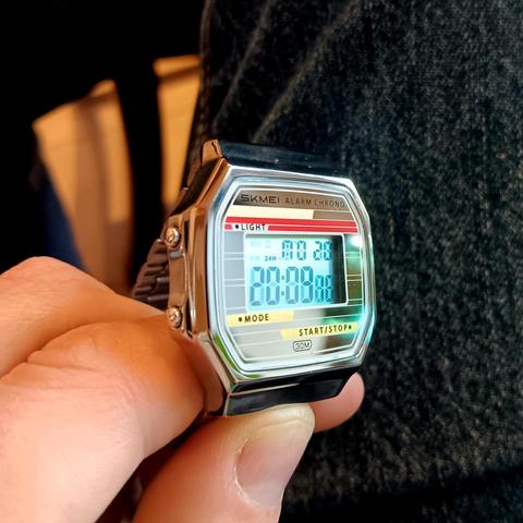 Skmei digital watch tiled rightwards. The time is readable but ghosting is starting to appear. 