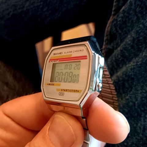 Skmei digital watch tiled leftwards. The time is readable but starting to have quite a lot of ghosting.