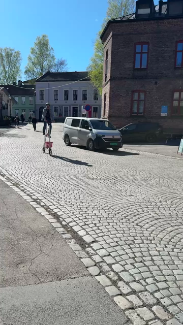 Man riding a tall pink and white bike with tiny wheels.

Someone off camera says, "This looks, umm… safe". The rider replies, "You wanna try it?"
