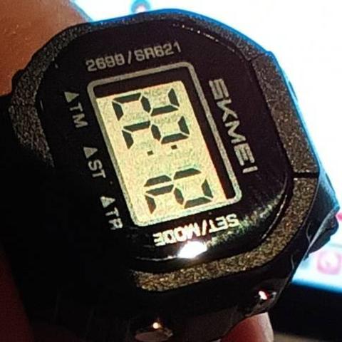 Close up of a Skmei digital ring watch. It is possible to see the code SR621 after the watch model number (2699)