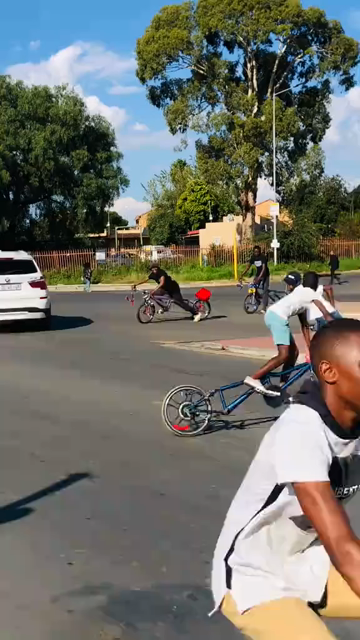 People skidding around and sliding on wierd long bikes