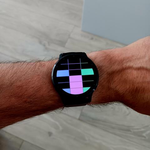 Binary watch made of lit and unlit squares that looks a bit like a face with the current data and time. 