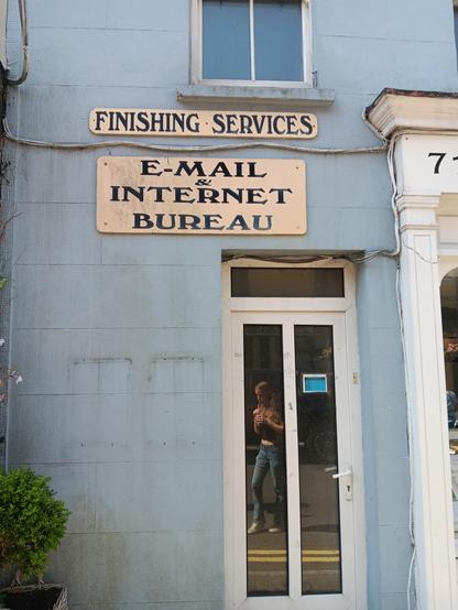 Old fashioned sign that read e-mail and internet bureau. 