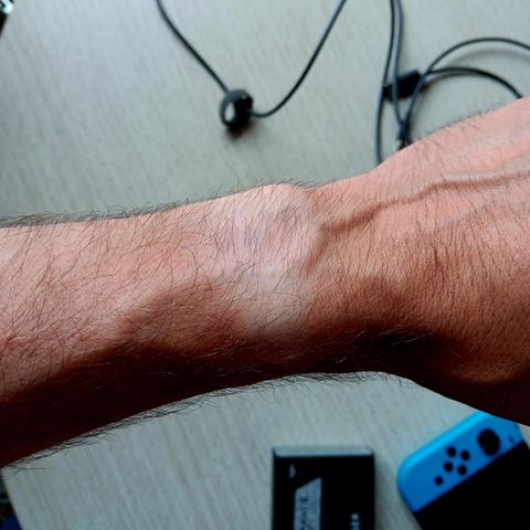 A 'naked' wrist that is lightly tanned but lighter where the watch would sit. 