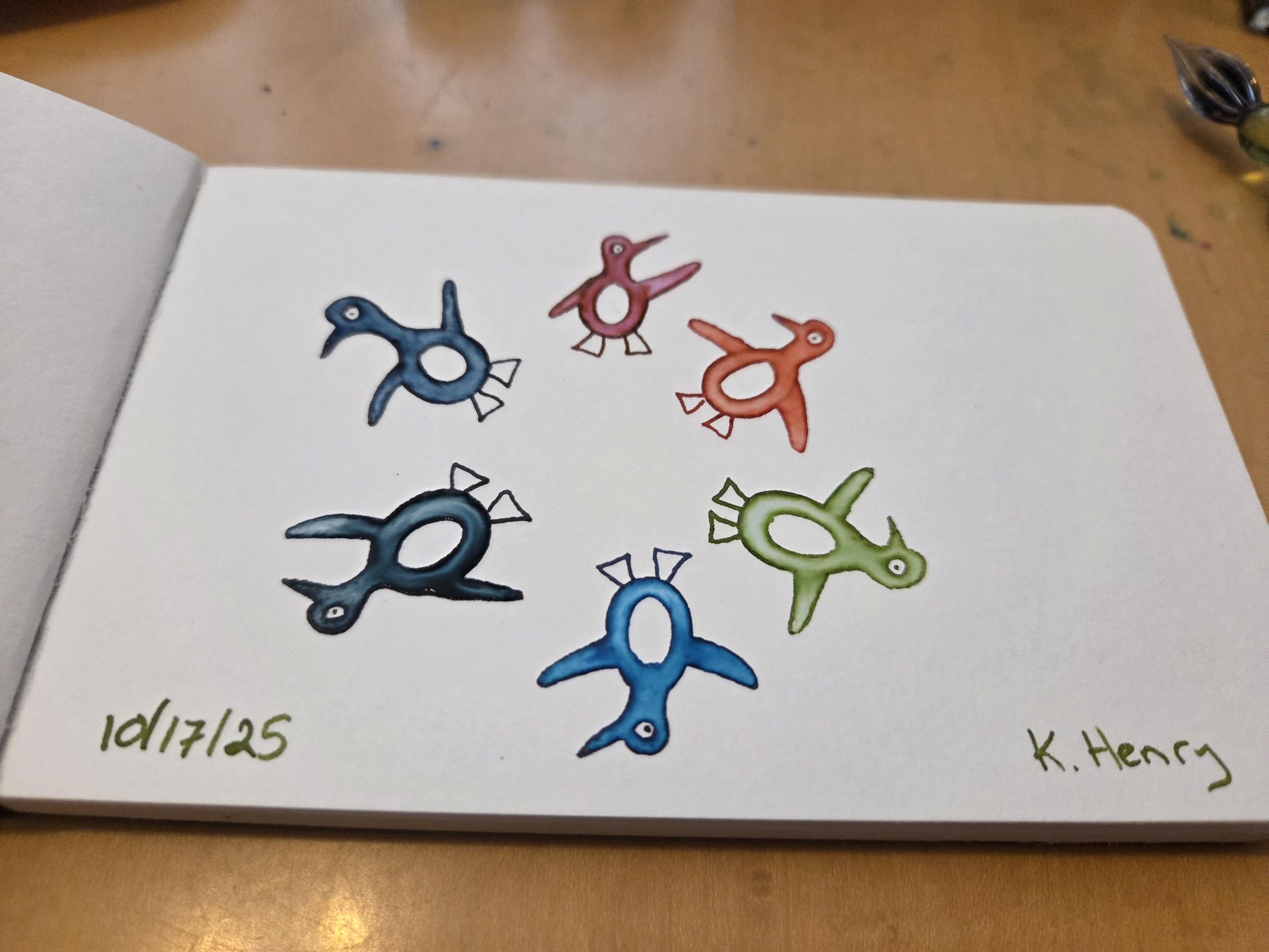 Hand drawn generative/procedural art in ink on an open page of my sketchbook. The abstract pattern looks like colorful penguins standing in s circle.