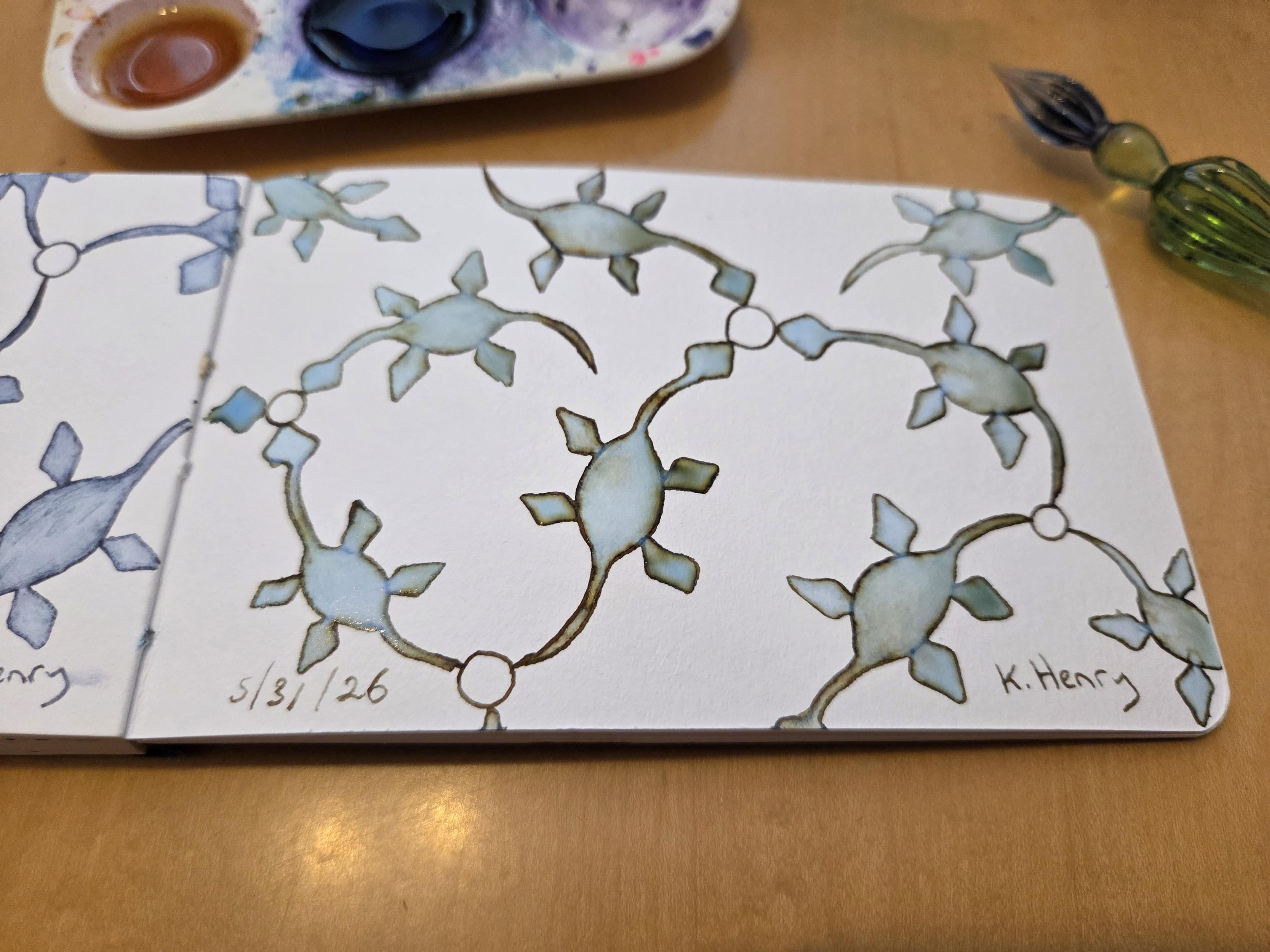 Hand drawn generative/procedural art in ink on an open page of my sketchbook. The abstract pattern looks a bit like a network of plesiosaurs. My glass dipping pen is next to my sketchbook.