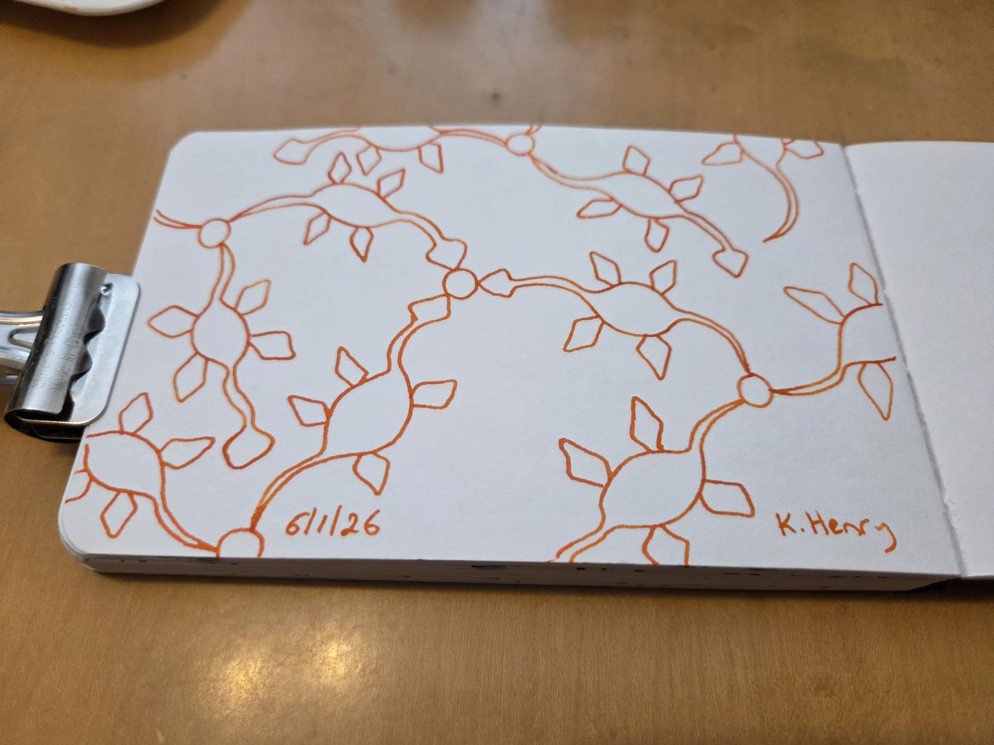 Hand drawn generative/procedural art in ink on an open page of my sketchbook. The abstract pattern looks a bit like a network diagram with plesiosaur shapes instead of straight lines for the edges.