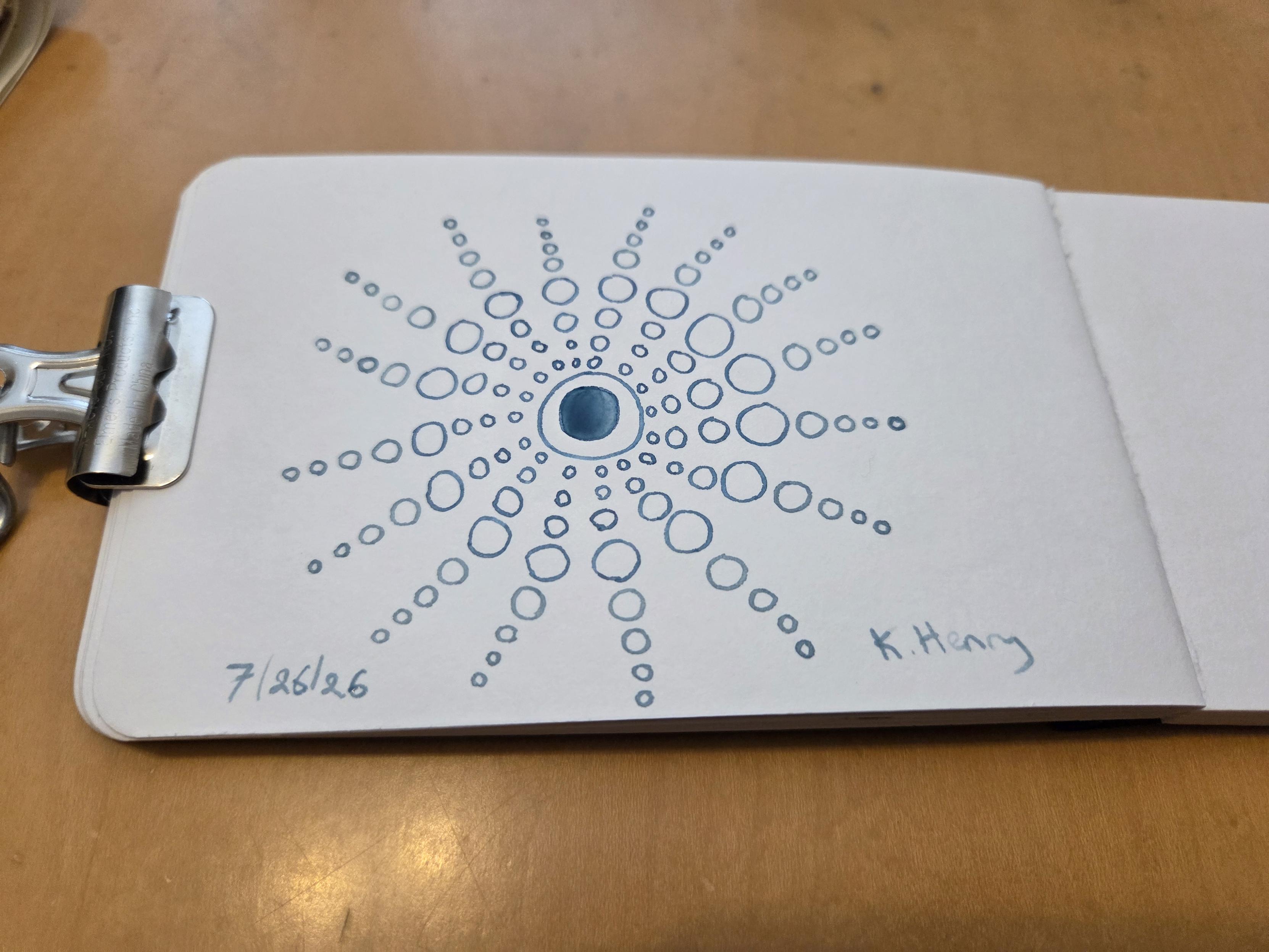 Hand drawn generative/procedural art in ink on an open page of my sketchbook. The abstract pattern is difficult to describe, but there are circles radiating out from a center.