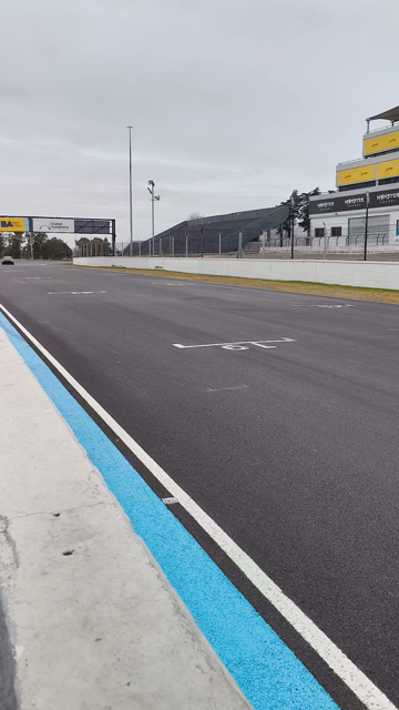 A black Toyota Yaris GR crossing the main straight of the Buenos Aires circuit