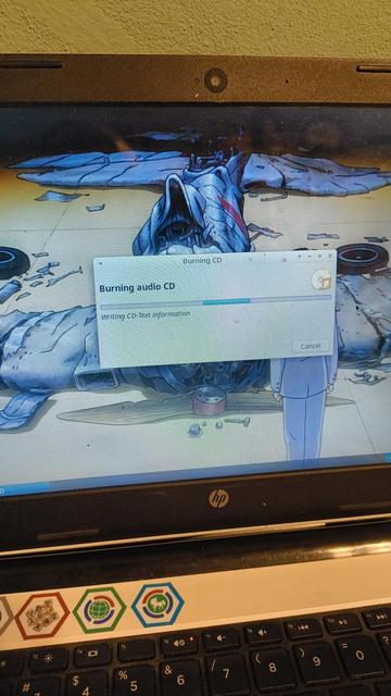 A photo of my laptop running a burning CD program, while burning a CD audio.