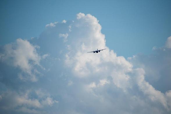 S-2 Turbo Tracker flying toward the clouds.