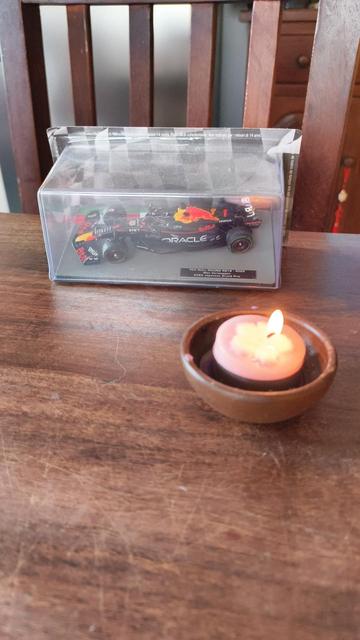 A scale model of the RB18 next to a candle