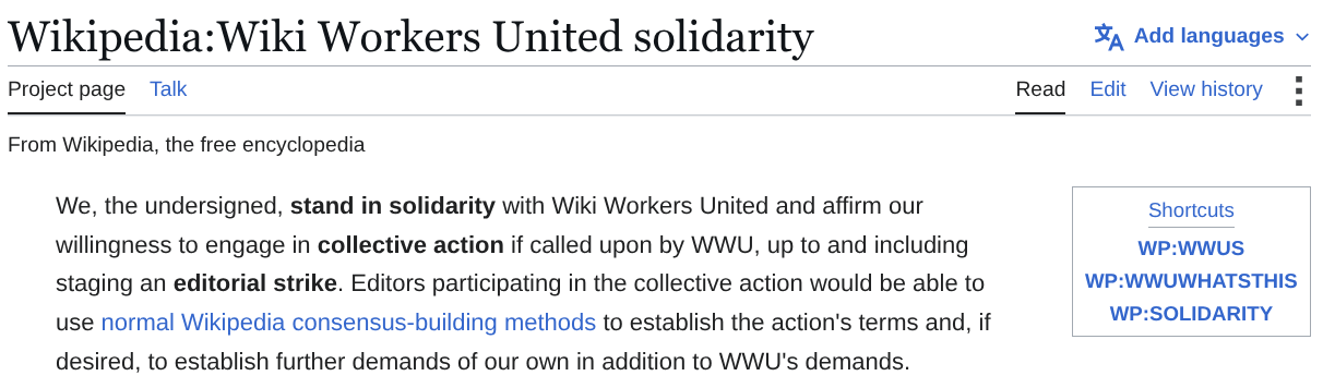 Screenshot of the Wikipedia page "Wikipedia:Wiki Workers United solidarity", with shortcuts "WP:WWUS", "WP:WWUWHATSTHIS", and "WP:SOLIDARITY", showing the petition's pledge: "We, the undersigned, stand in solidarity with Wiki Workers United and affirm our willingness to engage in collective action if called upon by WWU, up to and including staging an editorial strike. Editors participating in the collective action would be able to use normal Wikipedia consensus-building methods to establish the action's terms and, if desired, to establish further demands of our own in addition to WWU's demands."