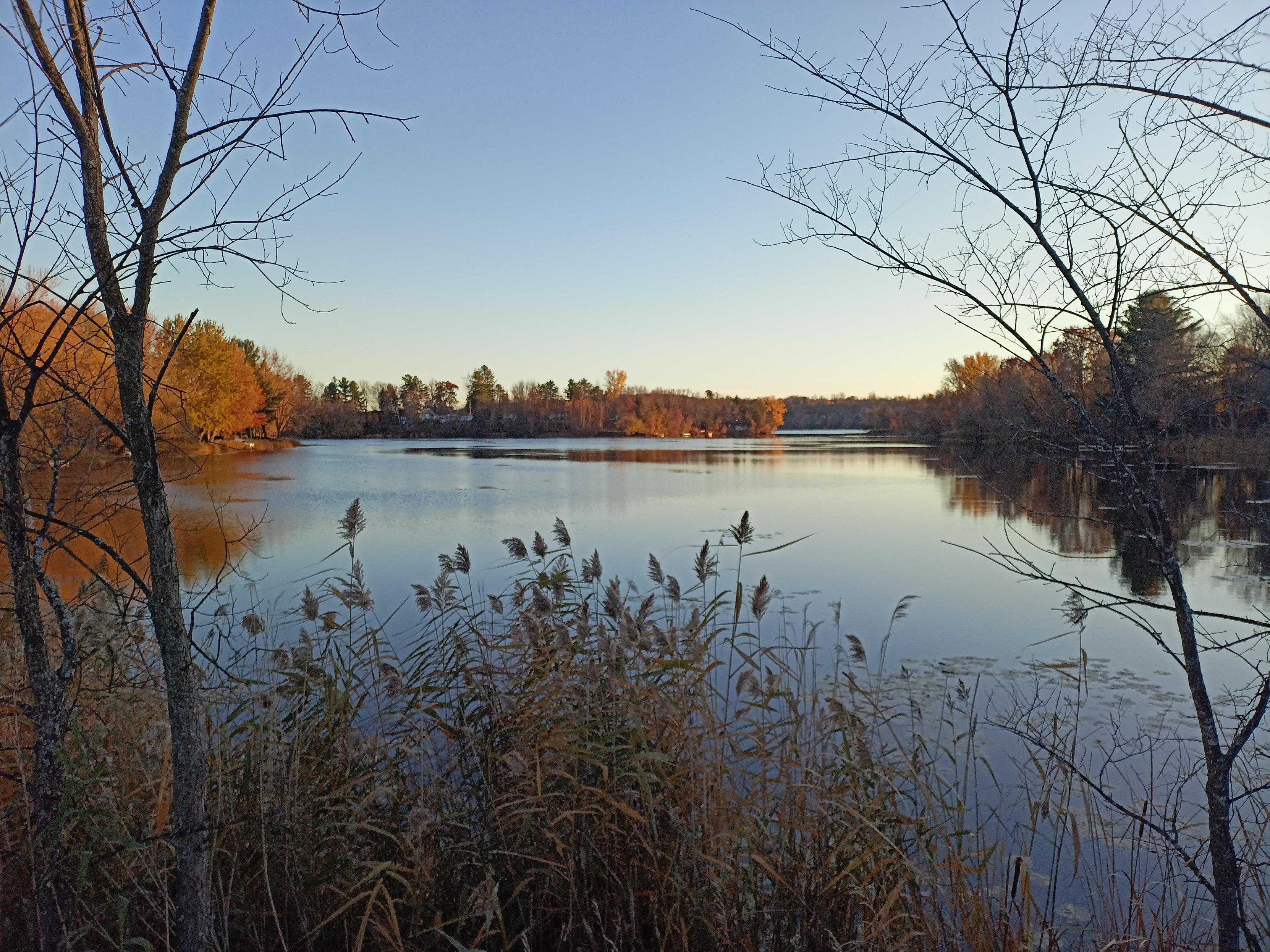 Beautiful Canadian lake with fall forest and evening light