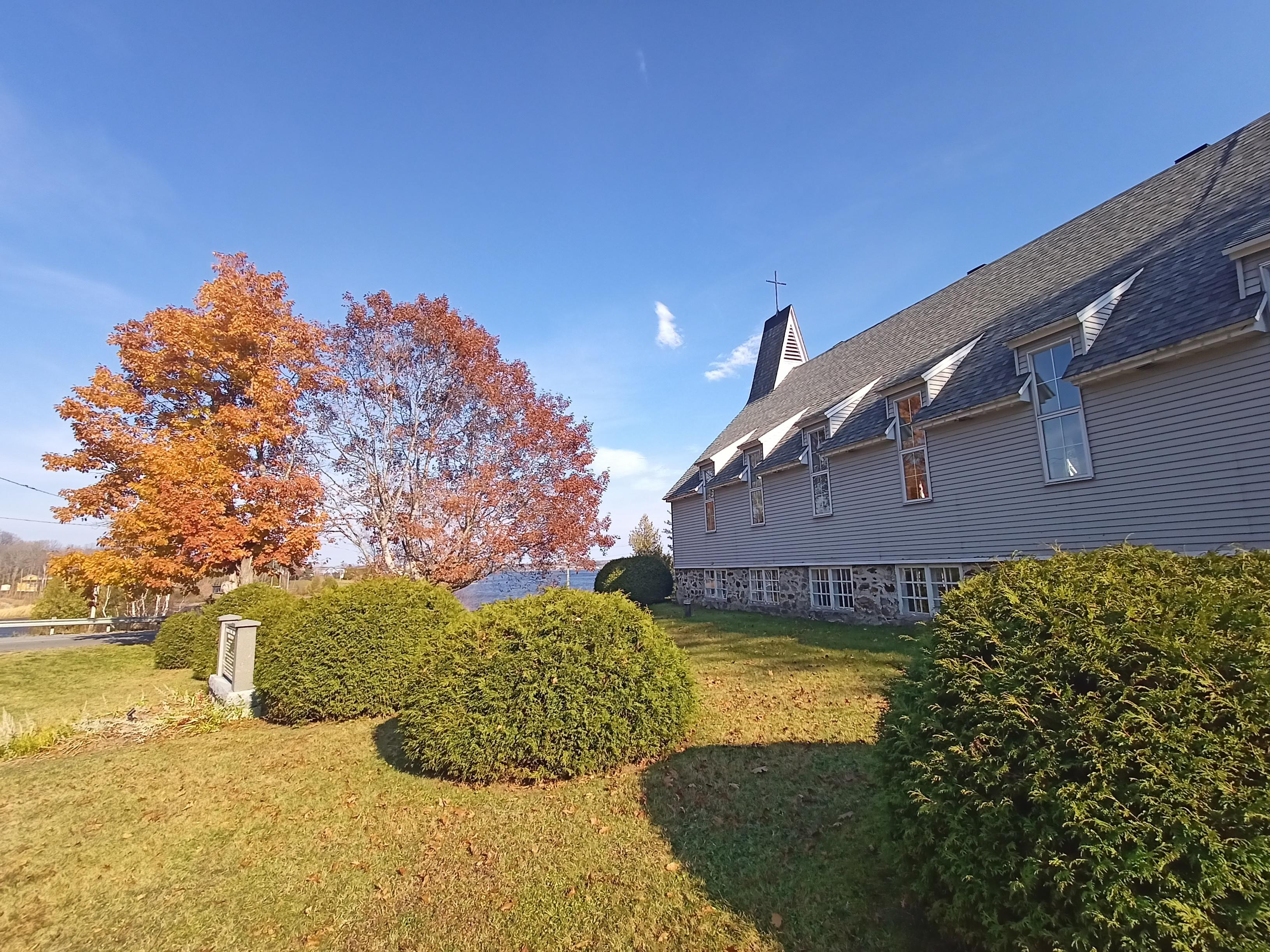 Chapel by the lake, trees with fall colours