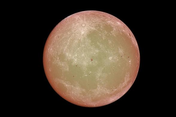 A transparent moon creating a total eclipse of the sun. Sunspots can be seen through the moon, and appear on some of the mare.